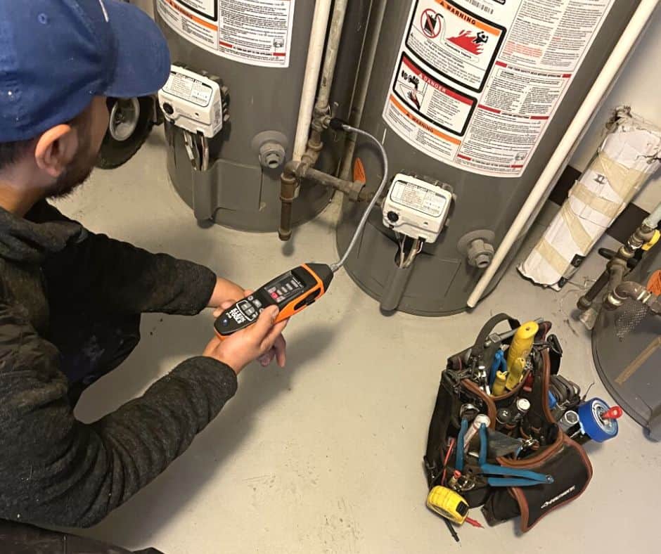 Service Tech Checking Water Heater for Gas Leak