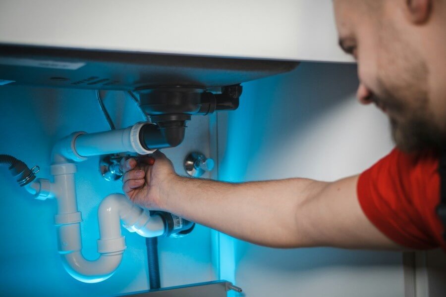 Man doing DIY home plumbing repairs